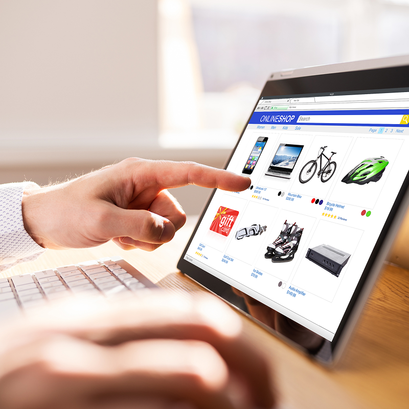 Customer browsing an online store and adding items to cart on a laptop