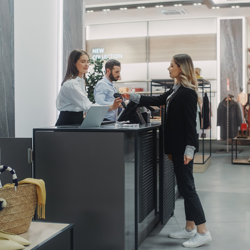 Customer making a payment on a digital POS system in a retail shop