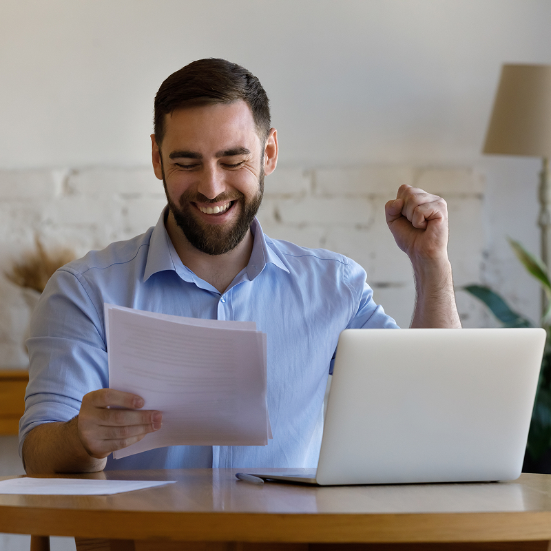 shutterstock_2093260732-img Happy young man looking at paper document feeling excited reading amazing news