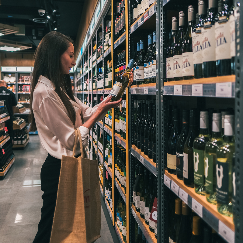 shutterstock_2192776153-img Woman in a liquor store shopping for wine taken at town