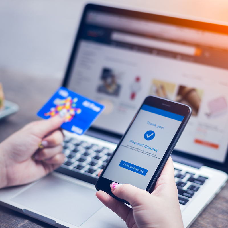 shutterstock_796031758-img Online shopping concept young woman hands holding mobile smart phone showing payment success on